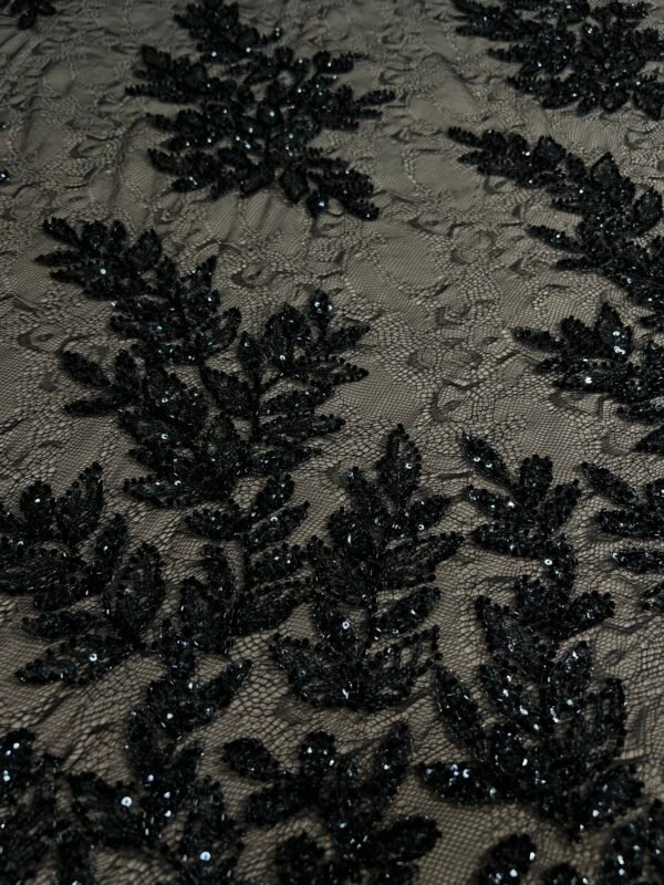 Black fabric with beaded branch and leaf pattern