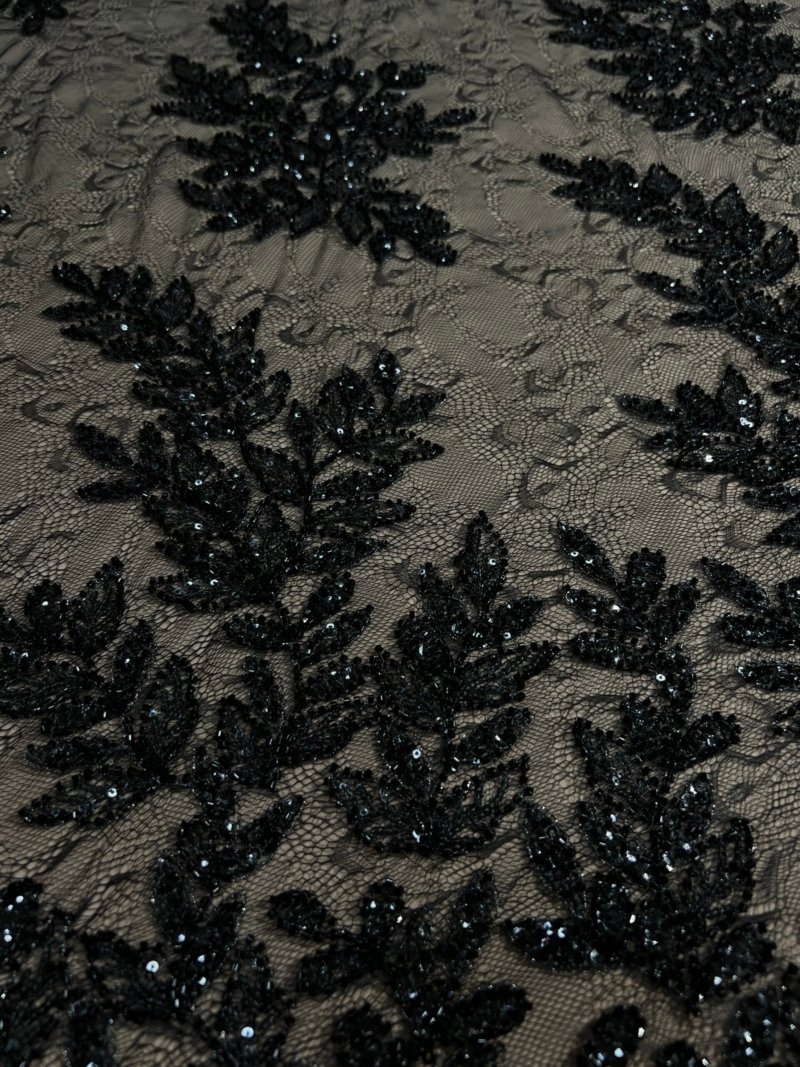 Black fabric with beaded branch and leaf pattern